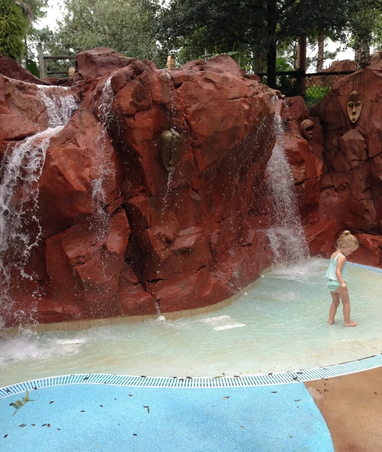 little girl playing in the rock waterfall area