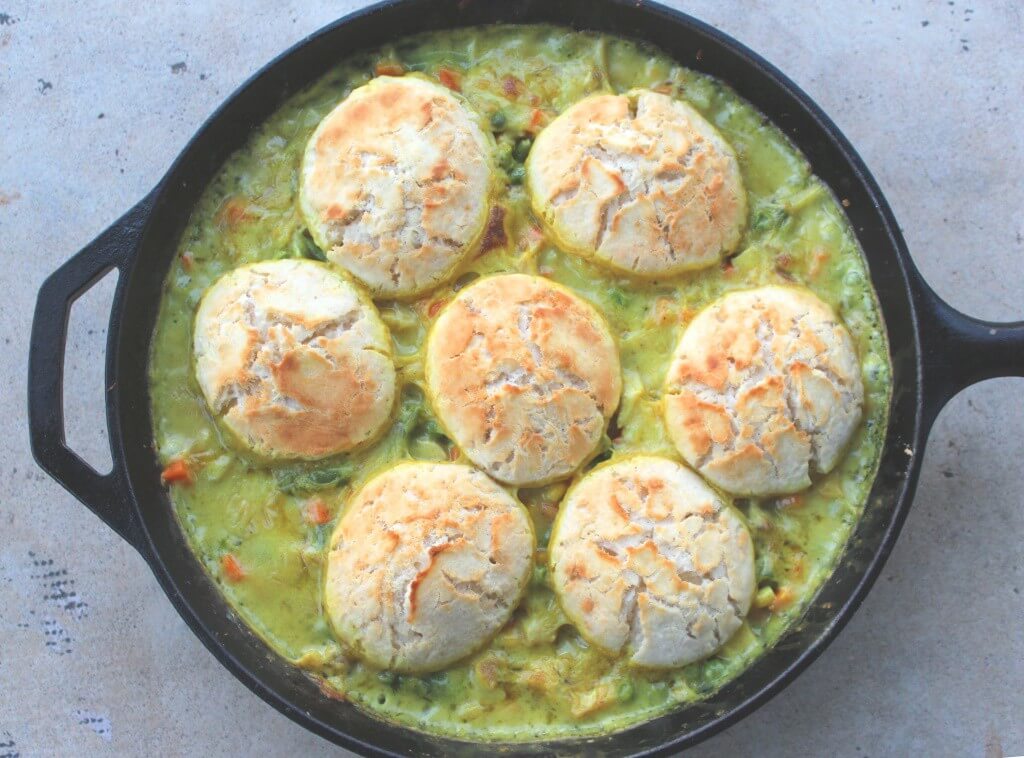 crustless chicken pot pie with biscuits on top in a skillet