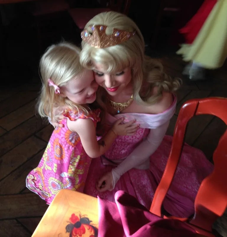 little girl hugging princess Aurora