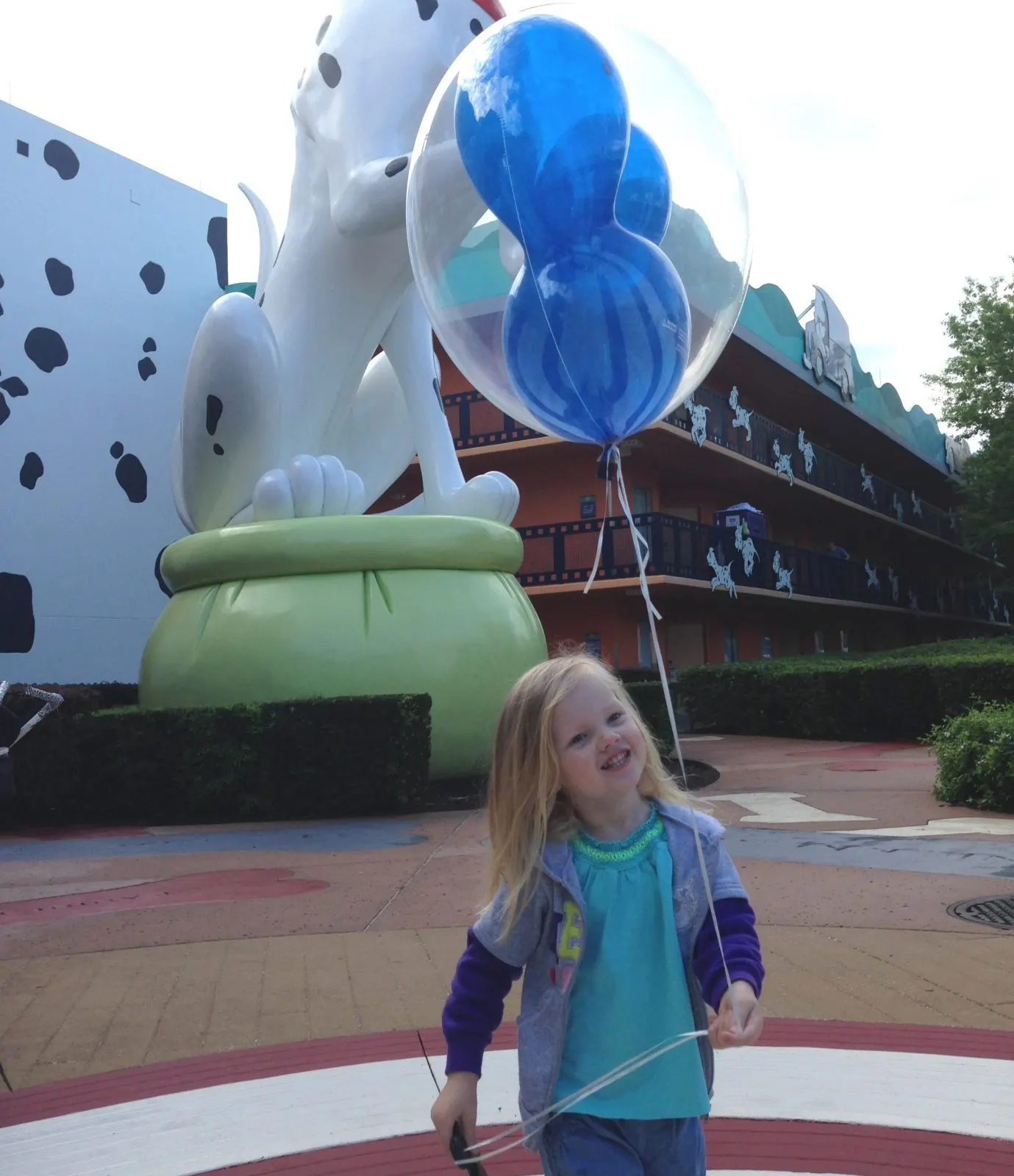 little girl with a mickey balloon