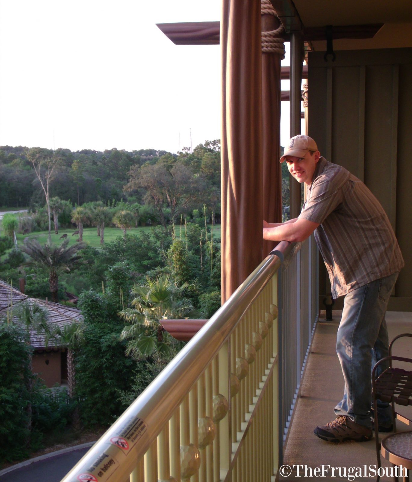 man on room balcony at Animal Kingdom Lodge Resort