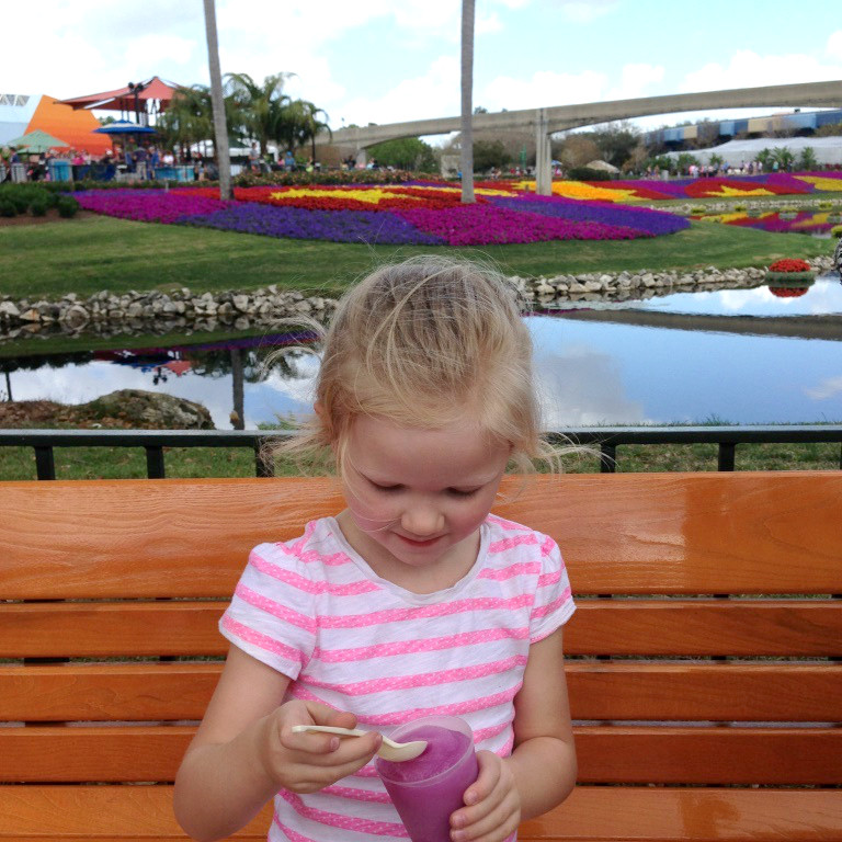 girl eating violet lemonade