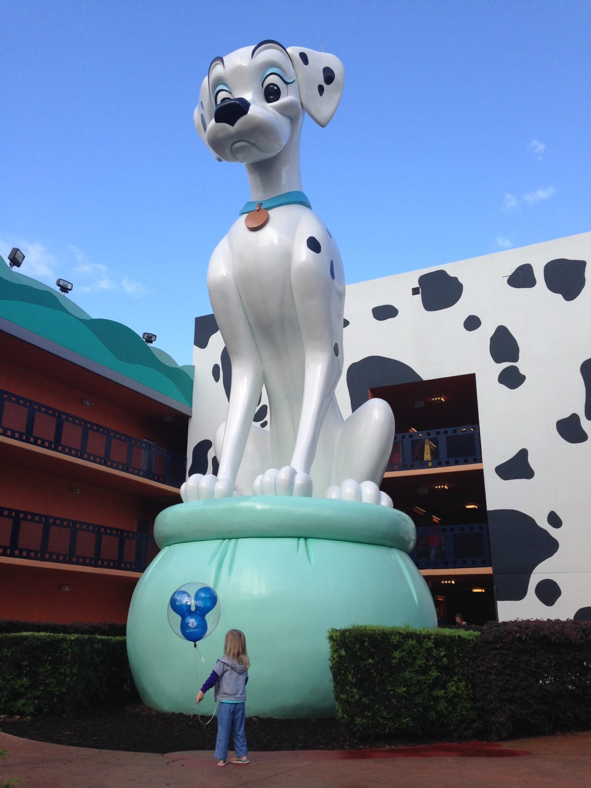 Little girl in front of 101 Dalmatians statue at All Star Movies Resort 