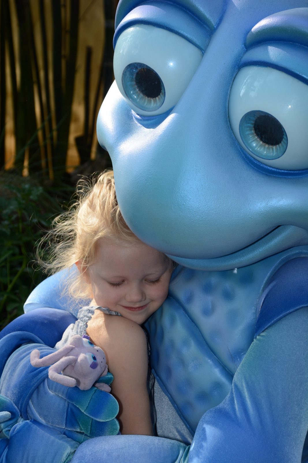 Disney character, Flick, hugging little girl