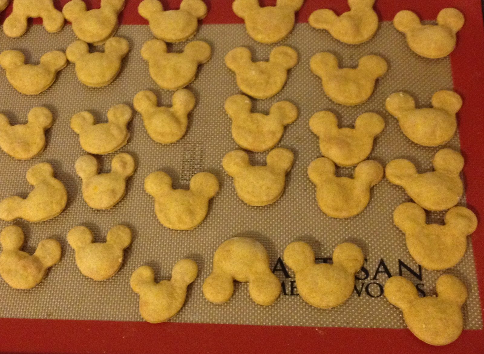 Mickey head shaped cookies on pan