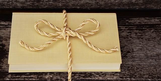 book with gold and white bow