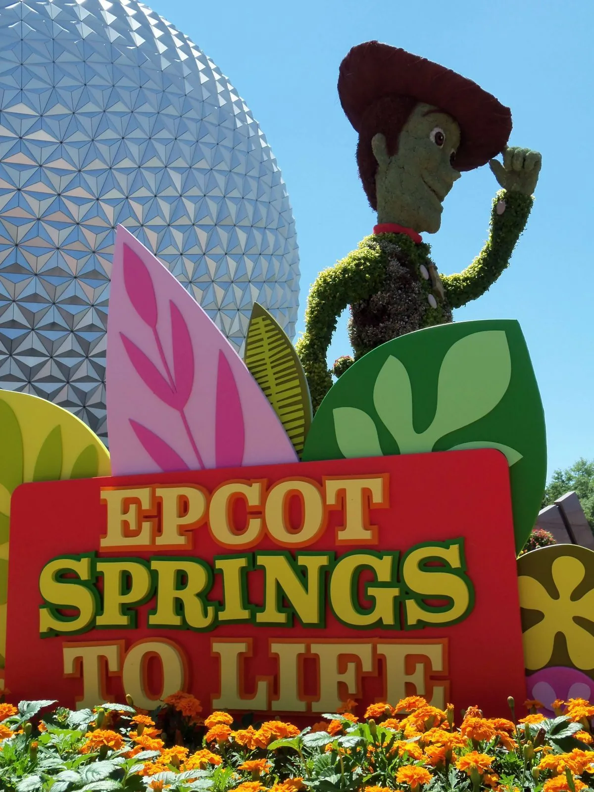 Woody in front of Epcot in Spring - best time to go to disney world