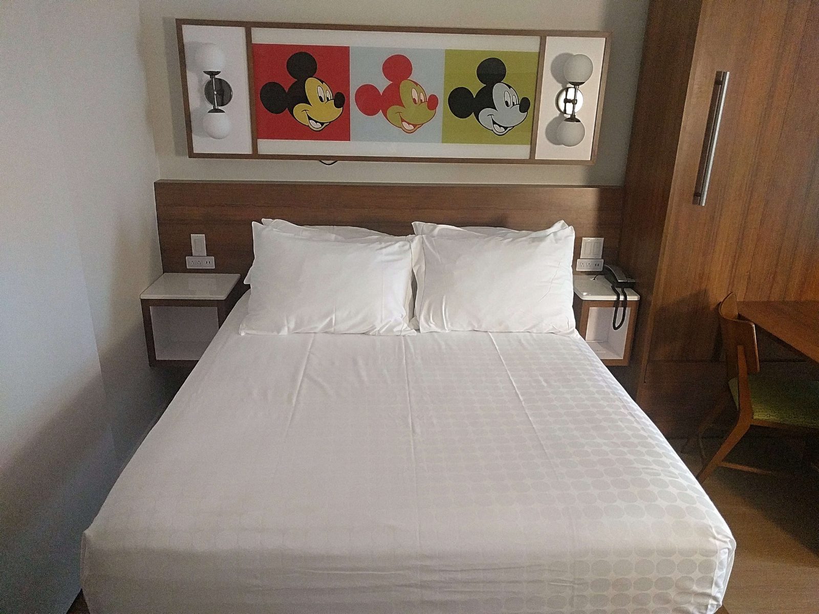 mickey themed room with white bed