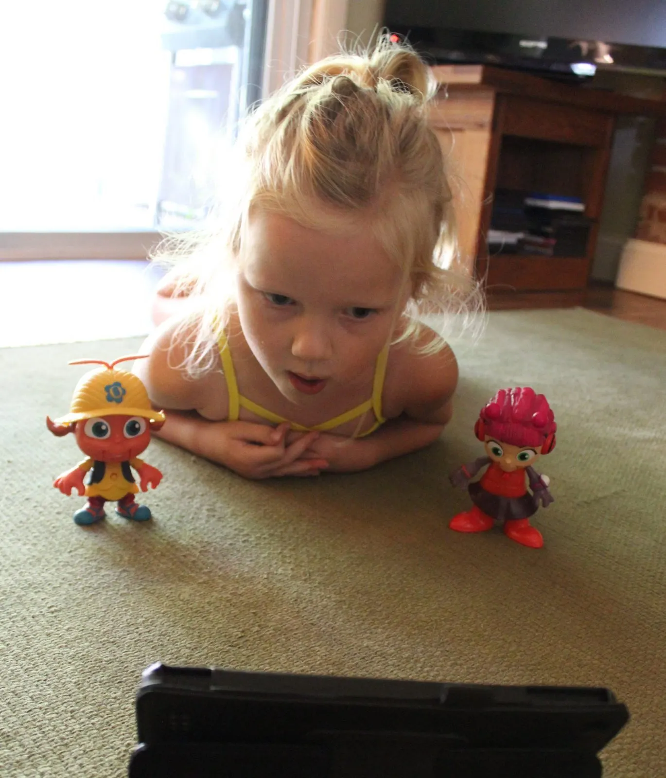 little girl playing with beat bugs toys