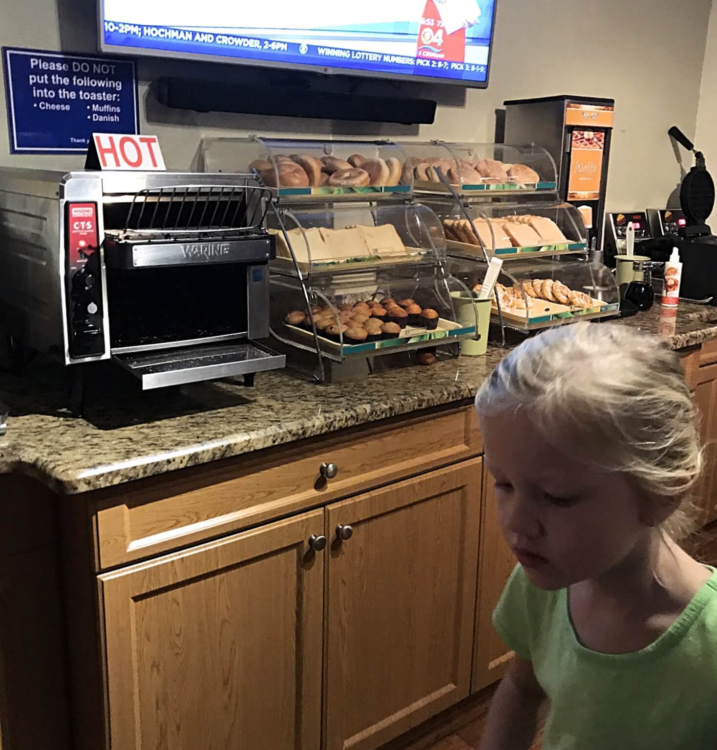 little girl getting a hotel breakfast