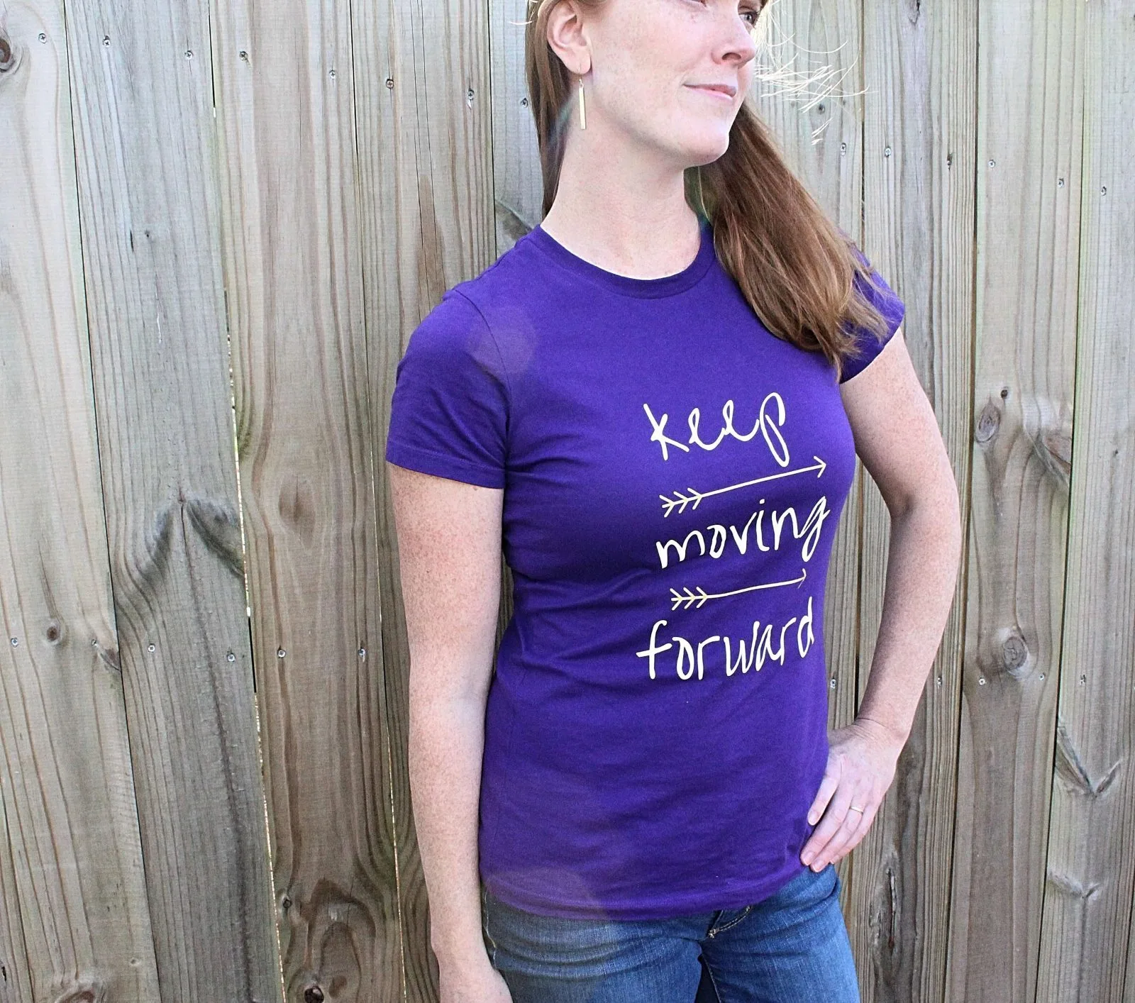 woman wearing a keep moving forward arrow t-shirt
