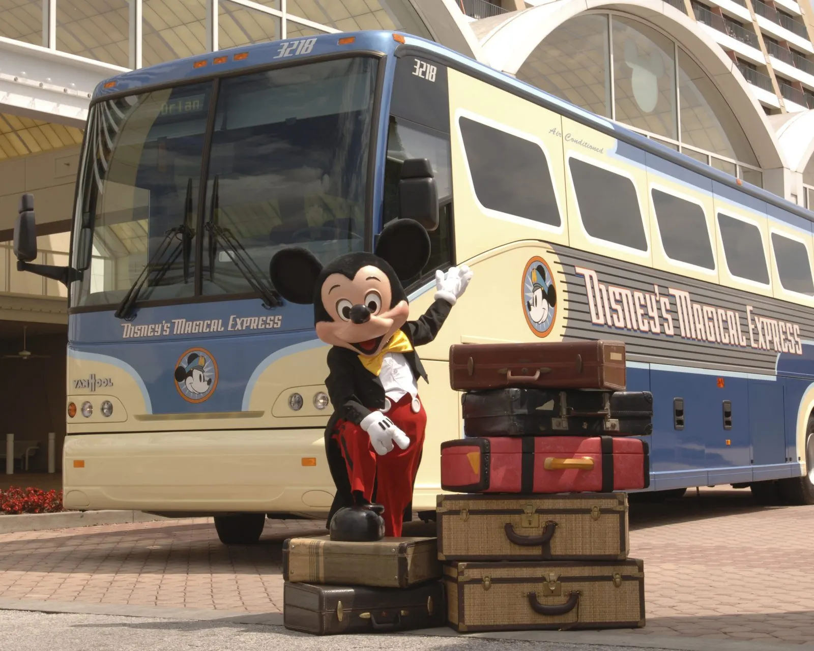 Disney Magical Express bus and Mickey Mouse with luggage