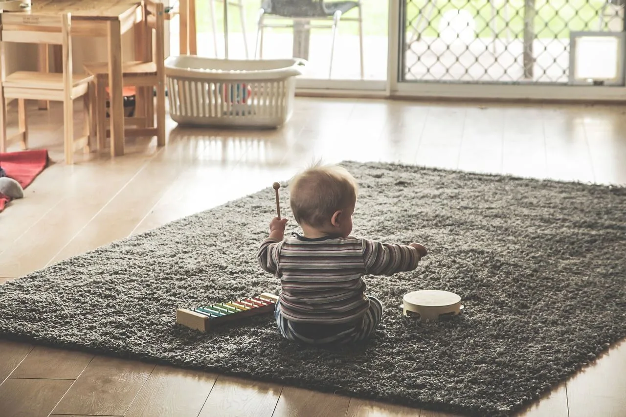 baby playing with toys on a rug