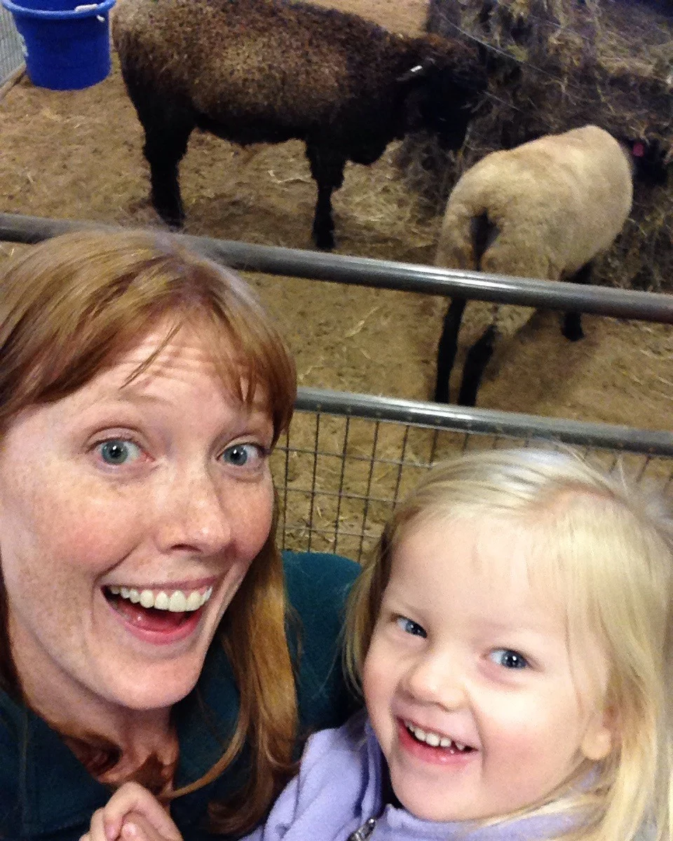 mother daughter selfie by the sheep