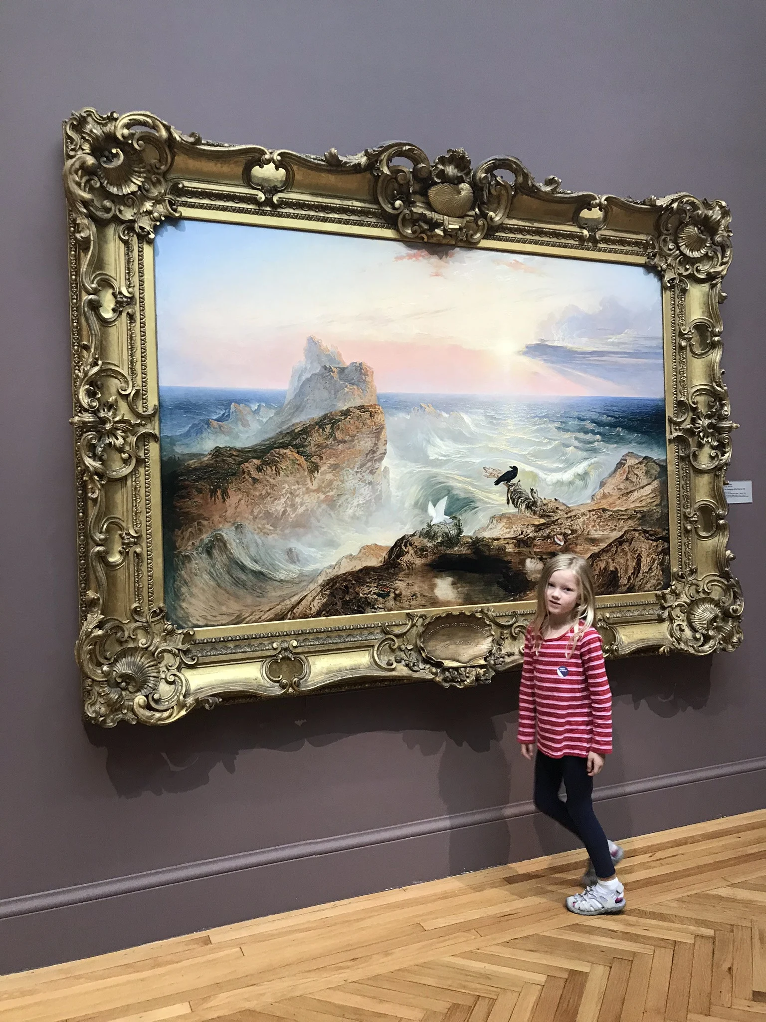little girl in front of painting