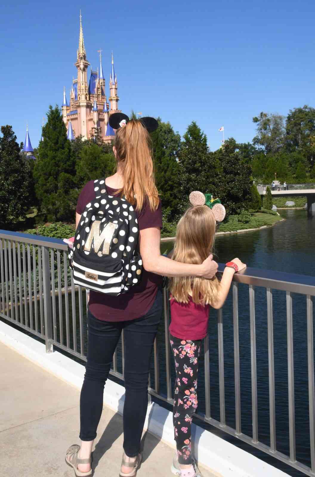 mom and daughter in front of cinderella castle