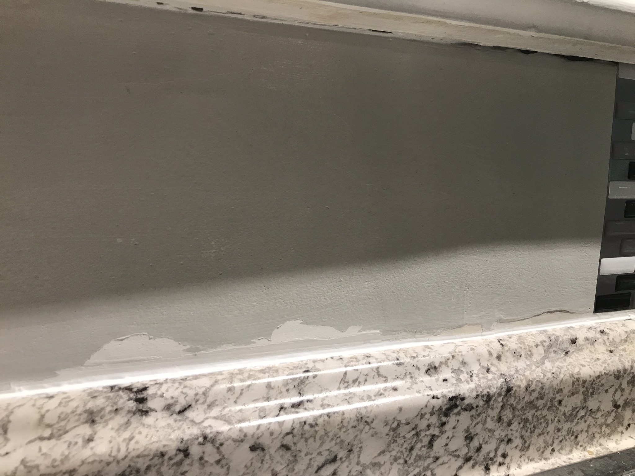 area behind sink with peeling paint
