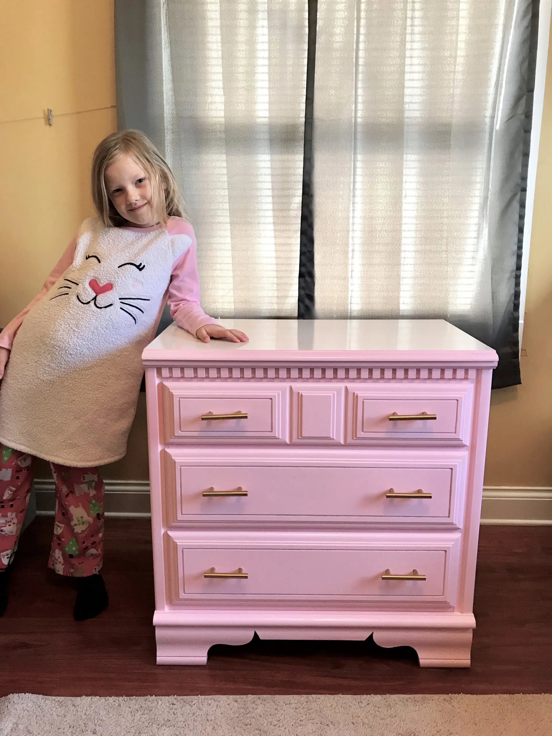 little girl beside her new finished chest of drawers