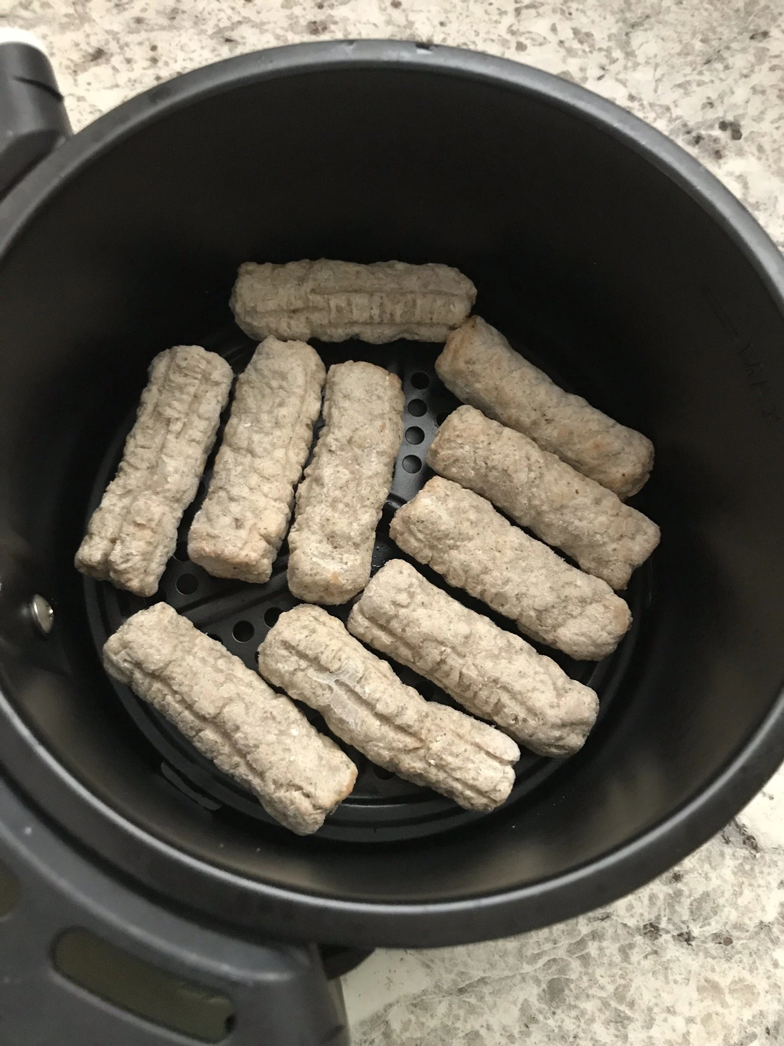 sausages inside the air fryer in a single layer