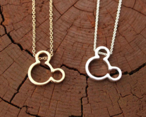 Two Mickey Mouse necklaces. One in silver and one in gold