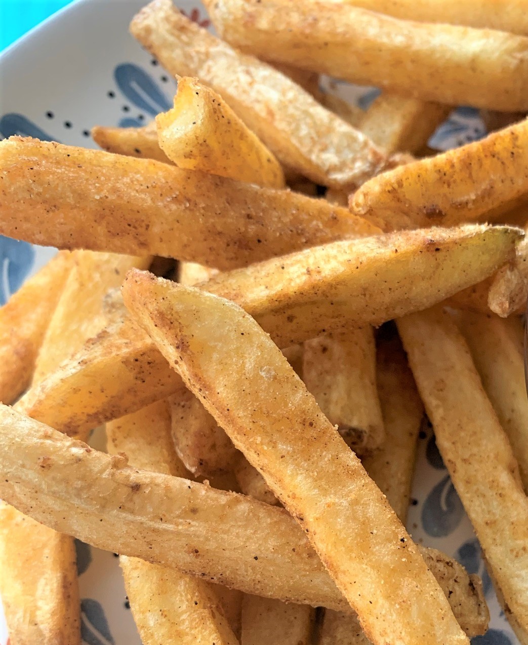 close up of air fryer frozen french fries on a plate