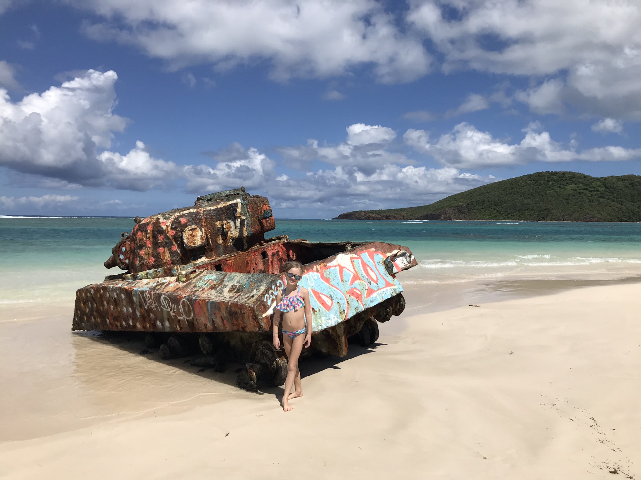 girl in front of tank at flamenco beach