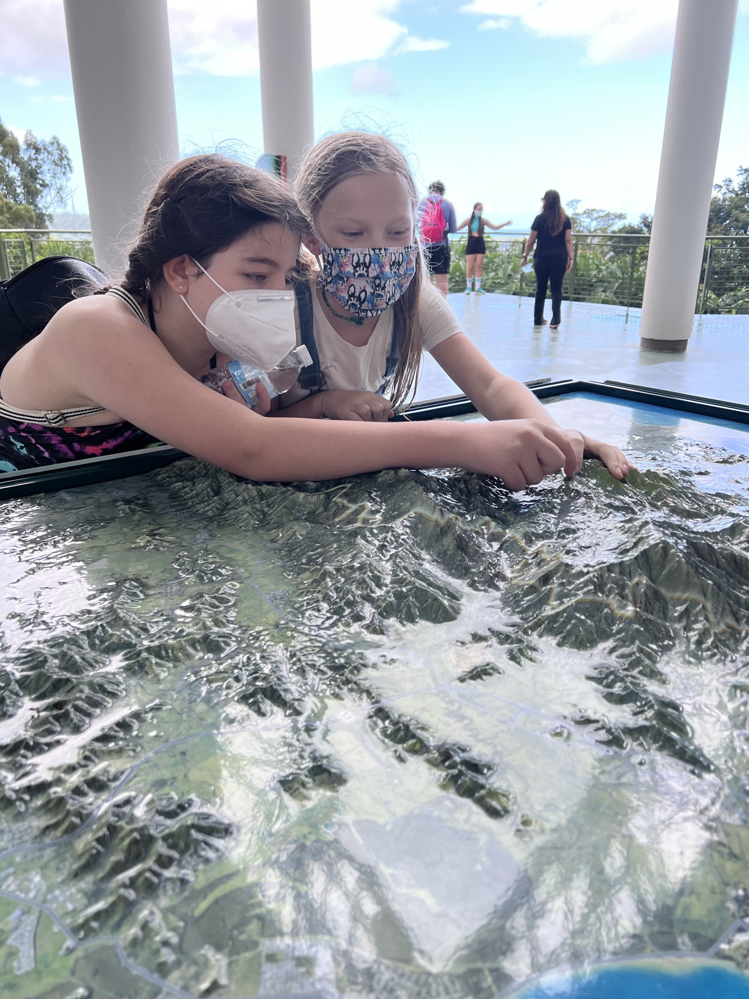 girls looking at map in puerto rico rainforest visitor center