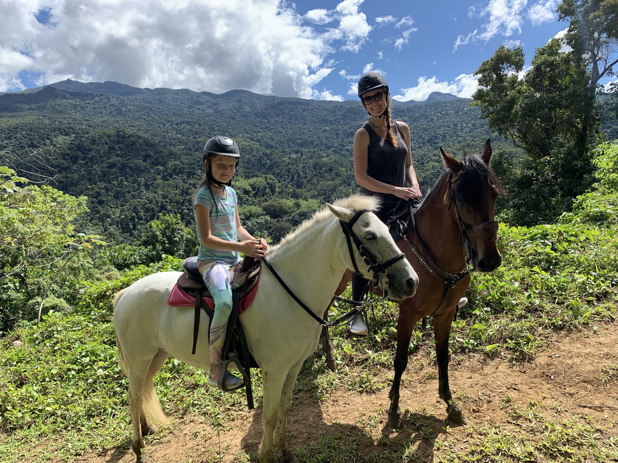 mom and daughter on horseback in el yunque rainforest
